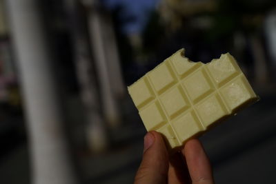 Close-up of hand holding ice cream cone