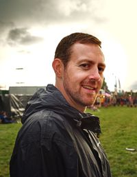 Portrait of smiling man standing against sky