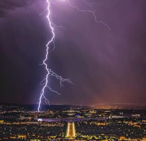 Lightning in sky over city at night