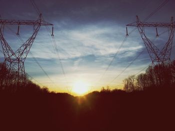 Low angle view of electricity pylon against sky