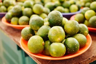 Close-up of limes in plate for sale at market