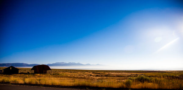 Scenic view of field against cloudy sky