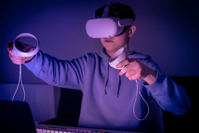 Teenager playing with virtual reality device futuristic mood experience with vr 3d viewer technology
