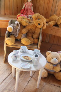 Teddy bears on chair with table