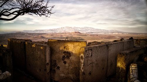 Scenic view of landscape and mountains against cloudy sky at golan heights