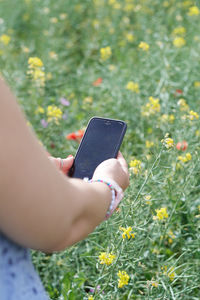 Midsection of woman using mobile phone