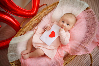 Valentine's day, little girl with valentine envelope