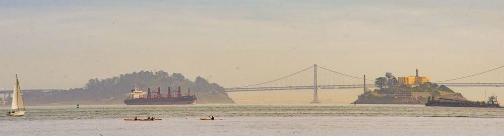 Sailboats in sea against clear sky