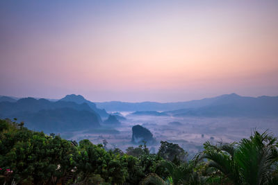 Scenic view of mountains against orange sky