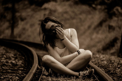 Young woman sitting outdoors