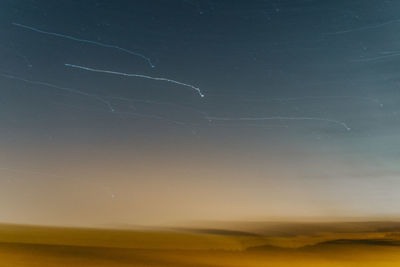 Scenic view of landscape against sky at night