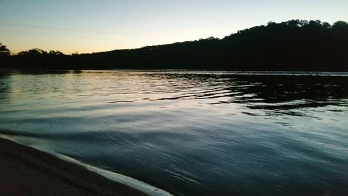 Scenic view of lake against sky at sunset