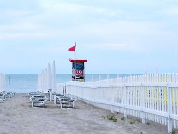 Lifeguard hut on beach against sky