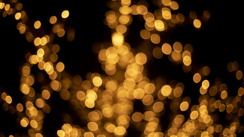 Garlands shot in blur. backdrop of lights in dark. lot of light bulbs are lit at festival. 