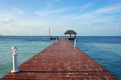 Pier over sea against sky