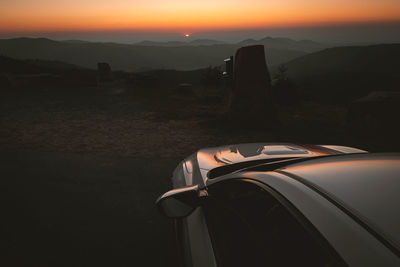 Car on road against sky during sunset