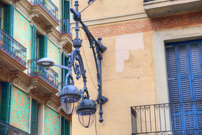 Low angle view of street light against building