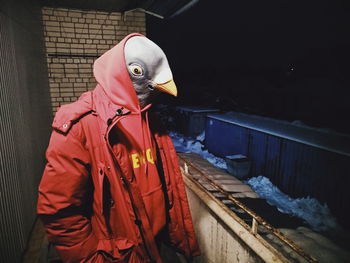 Side view of person standing by railing during winter