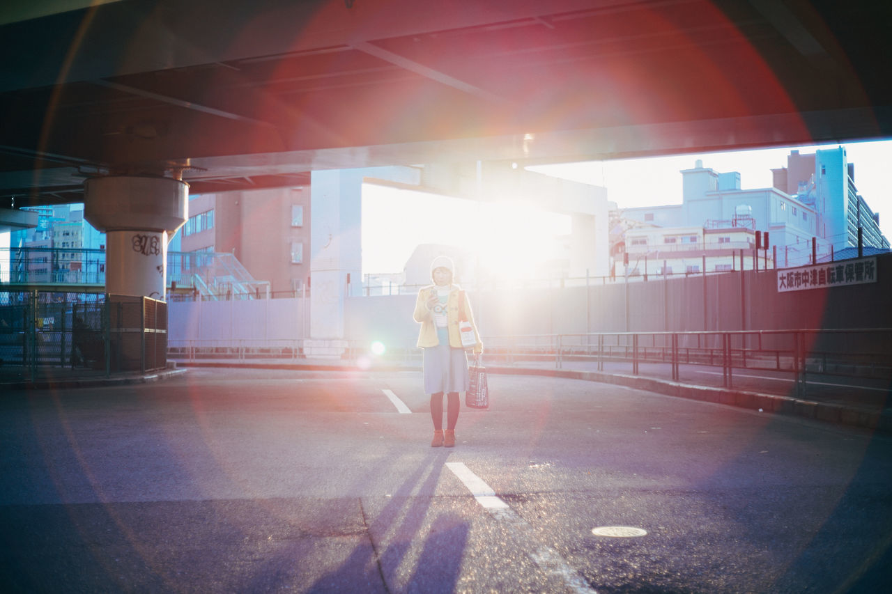 architecture, built structure, transportation, the way forward, street, sunlight, building exterior, road, city, indoors, sunbeam, city life, graffiti, incidental people, sidewalk, land vehicle, building, empty