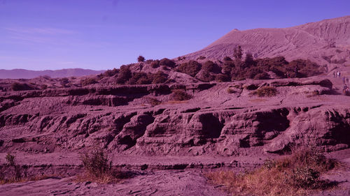 Rock formations on landscape against sky