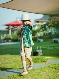 Full length portrait of happy boy playing outdoors