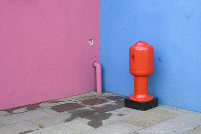 Red fire hydrant on wall