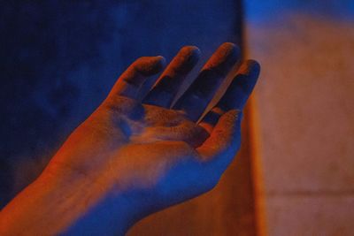 Cropped image of hand in front of wall