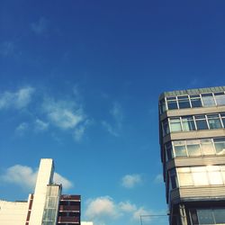 Low angle view of modern building against blue sky