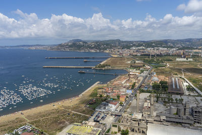 High angle view of buildings and sea against sky
