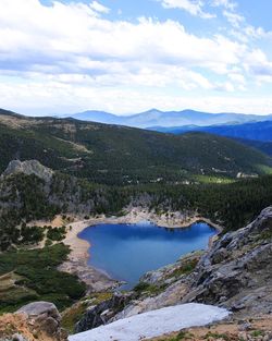 Scenic view of mountains against cloudy sky