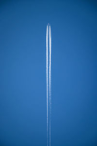 Airplane flying against clear blue sky