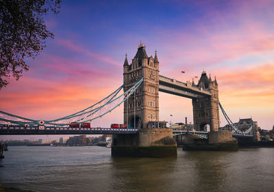 View of bridge over river at sunset