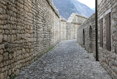 Ancient wall with stones in the medieval village