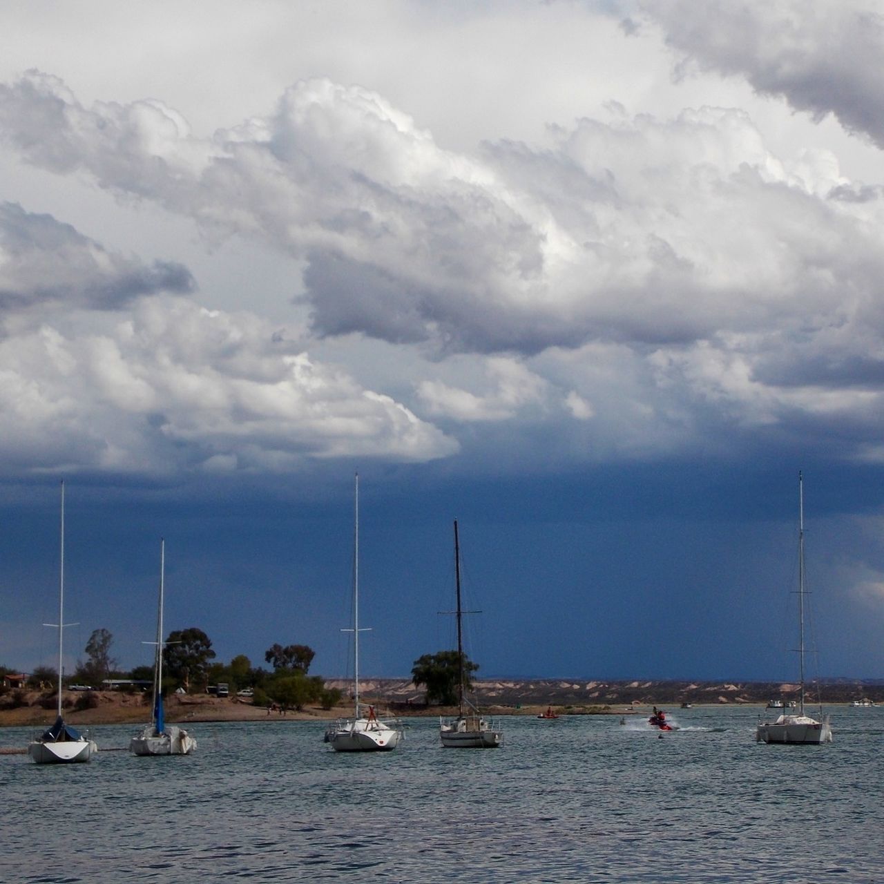 nautical vessel, transportation, mode of transport, boat, water, moored, sky, sea, cloud - sky, mast, sailboat, cloudy, travel, cloud, nature, waterfront, tranquility, harbor, scenics, beauty in nature