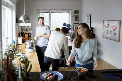 Happy family preparing food in kitchen