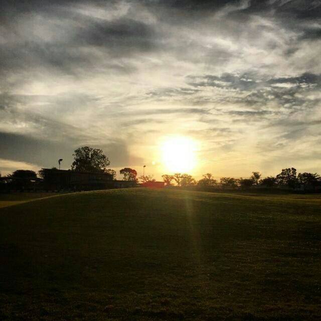 sunset, sky, sun, tranquil scene, landscape, tranquility, cloud - sky, scenics, field, beauty in nature, tree, nature, sunlight, sunbeam, grass, cloudy, cloud, idyllic, rural scene, lens flare