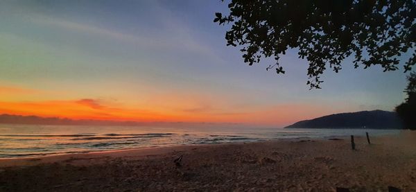 Scenic view of beach against sky during sunset