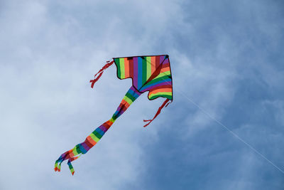 Low angle view of colorful kite flying against sky