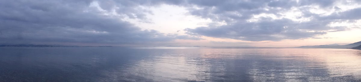 Panoramic view of sea against sky at sunset