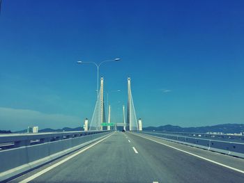 View of suspension bridge against blue sky