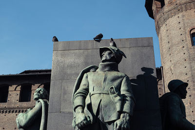 Low angle view of statue against building