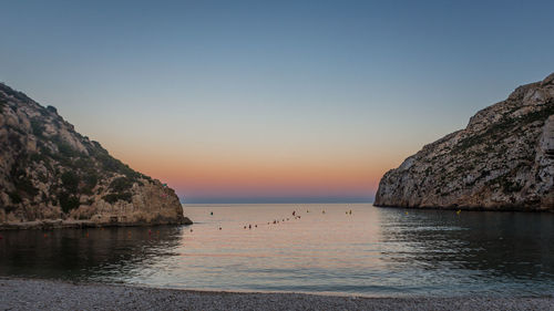 Scenic view of sea against clear sky during sunset