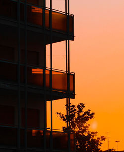 Low angle view of building against sky at sunset