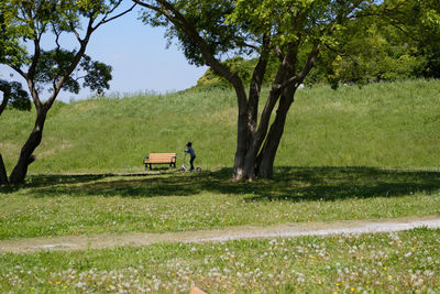 Man on golf course against sky