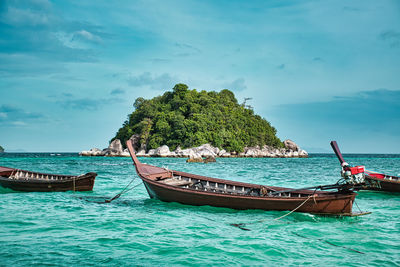 Thai traditional long tail boats resting on the shores of the magical island koh lipe