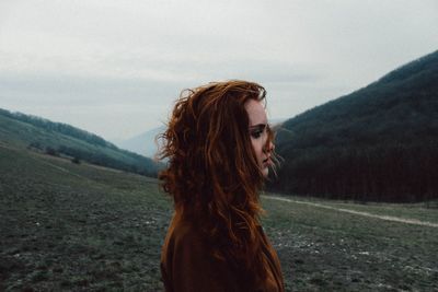 Woman standing on grassy field