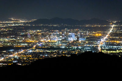 High angle view of illuminated buildings in city at night