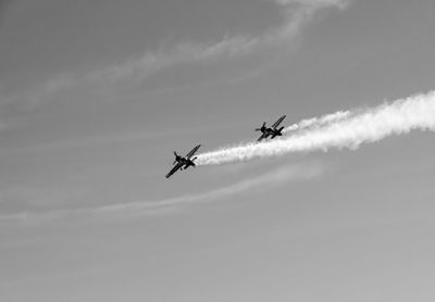 Low angle view of airplane flying in sky