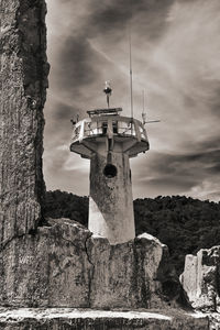 Old tower on rock against sky