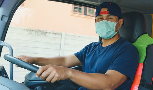 Portrait of man sitting in car